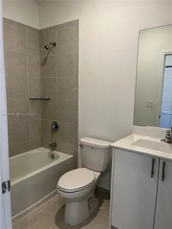 a white toilet sitting next to a bath tub