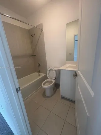 a view of a hallway with closet and wooden door
