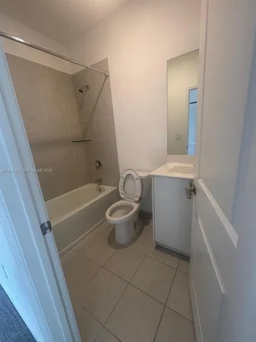 a view of a hallway with closet and wooden door