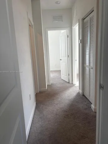a view of a hallway with closet area
