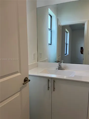 a bathroom with a sink toilet and a mirror