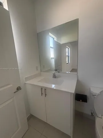 a white toilet sitting next to a bathroom sink
