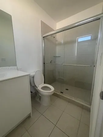 a white toilet sitting next to a bathroom sink