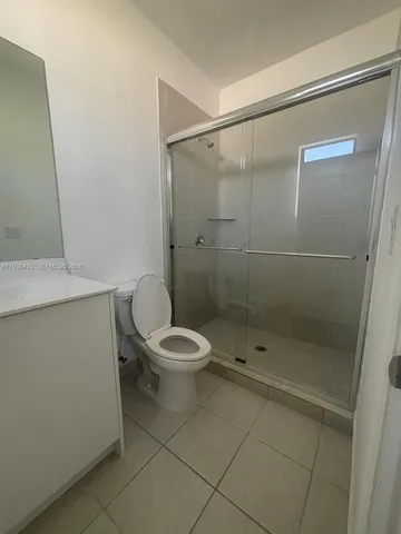 a white toilet sitting next to a bathroom sink