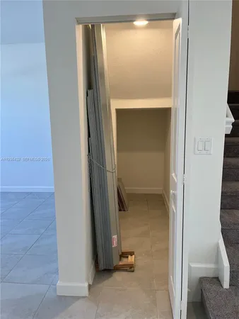 an empty room with windows and closet