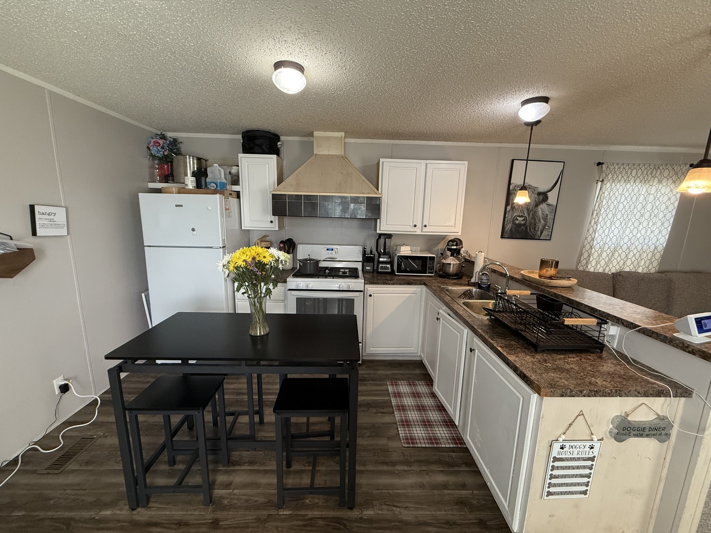 38455 North Sheridan Road, Unit 768 Beach Park, IL 60087 - Photo 4 of 15 a kitchen with a table chairs stove and cabinets