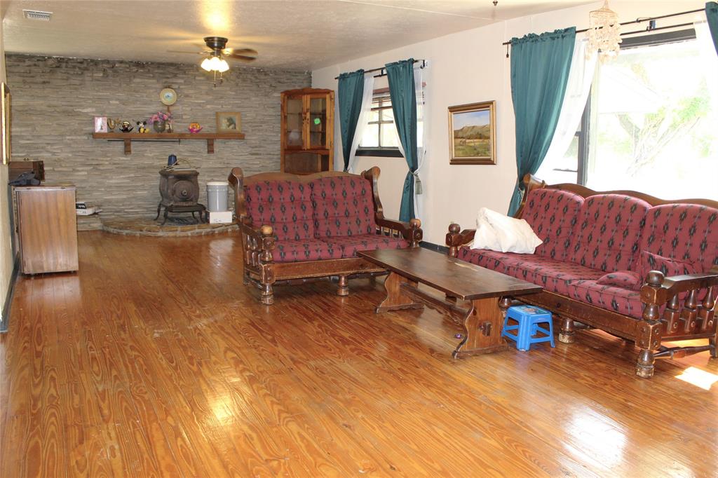 312 Magnolia Street Hico, TX 76457 - Photo 3 of 16 a living room with furniture and a wooden floor