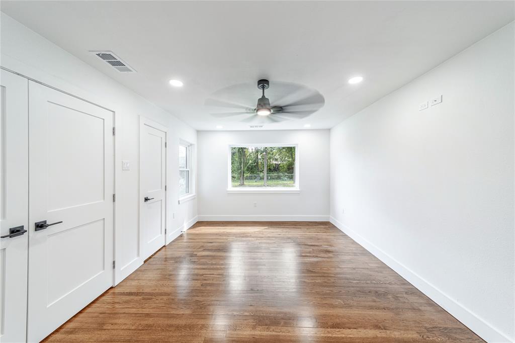 932 Treasure Road Garland, TX 75041 - Photo 13 of 23 wooden floor in an empty room with a window