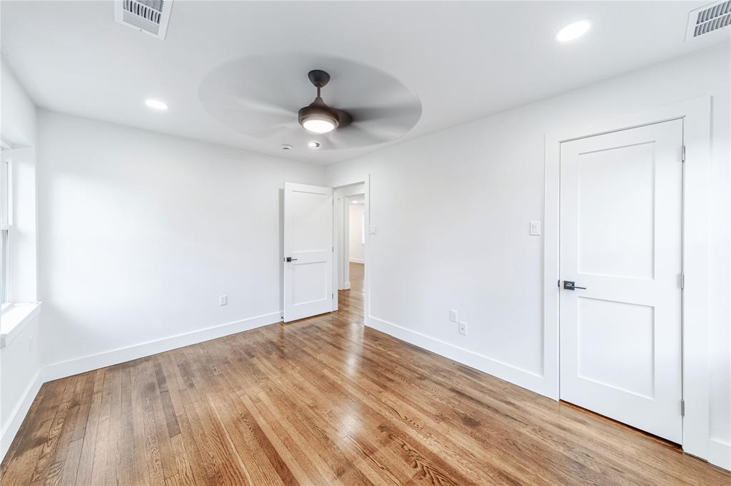 932 Treasure Road Garland, TX 75041 - Photo 16 of 23 an empty room with wooden floor and windows