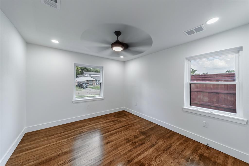 932 Treasure Road Garland, TX 75041 - Photo 18 of 23 a view of an empty room with a window and wooden floor