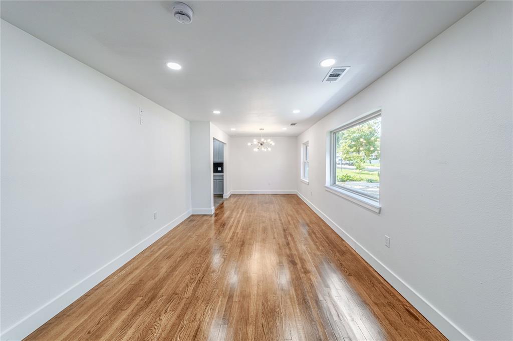 932 Treasure Road Garland, TX 75041 - Photo 4 of 23 wooden floor in an empty room with a window