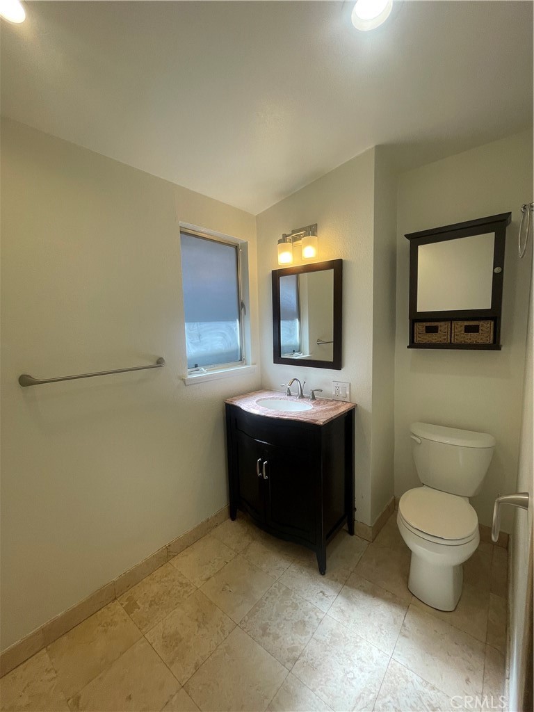 528 Cherry, Unit B Long Beach, CA 90802 - Photo 13 of 16 a bathroom with a toilet sink and mirror