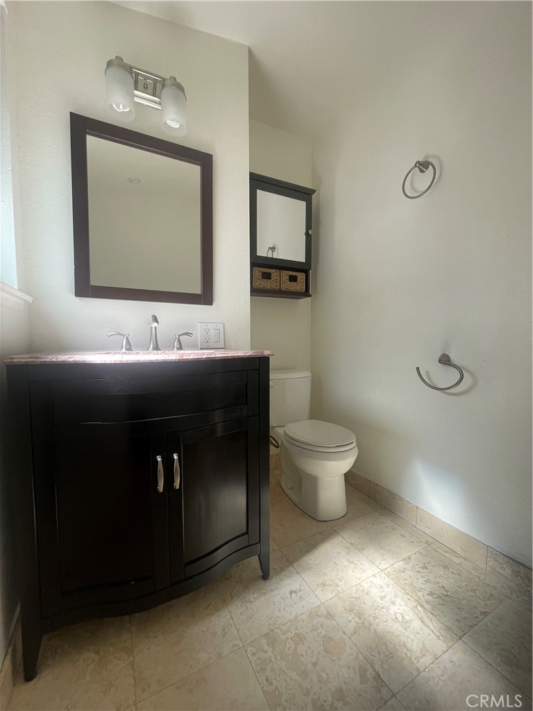 528 Cherry, Unit B Long Beach, CA 90802 - Photo 14 of 16 a bathroom with a toilet sink and mirror