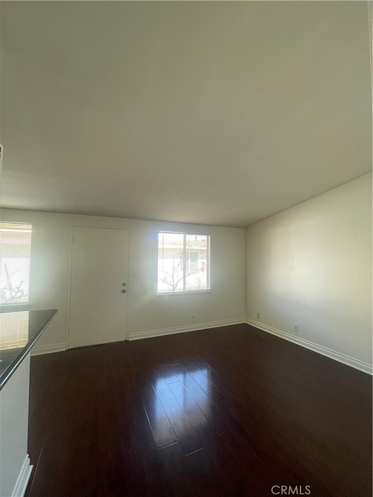 528 Cherry, Unit B Long Beach, CA 90802 - Photo 4 of 16 an empty room with wooden floor and windows