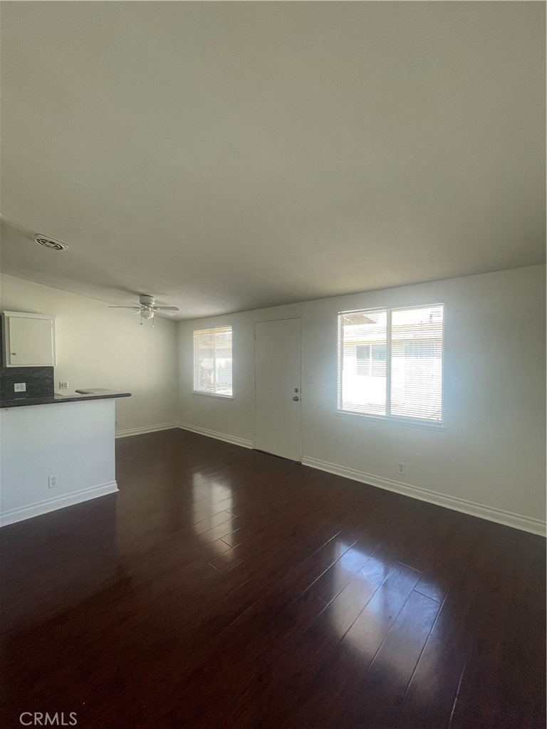 528 Cherry, Unit B Long Beach, CA 90802 - Photo 5 of 16 a view of an empty room with wooden floor and a window