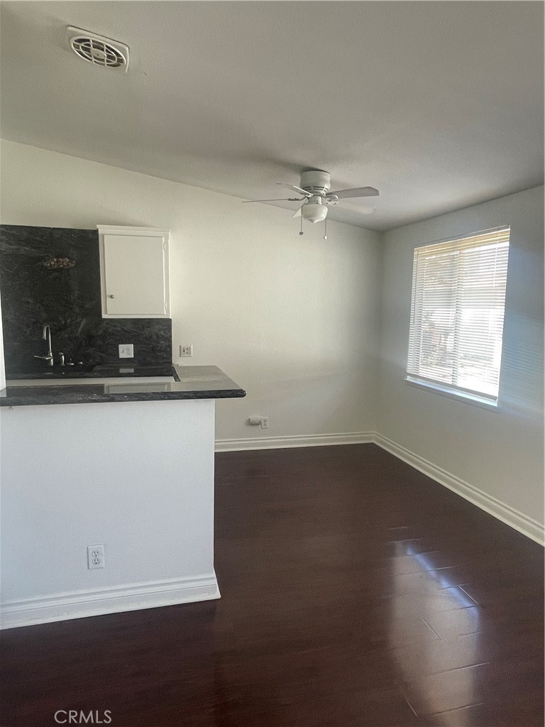 528 Cherry, Unit B Long Beach, CA 90802 - Photo 6 of 16 an empty room with wooden floor cabinet and a sink