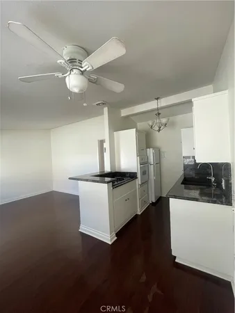 a kitchen with stainless steel appliances a sink and a refrigerator