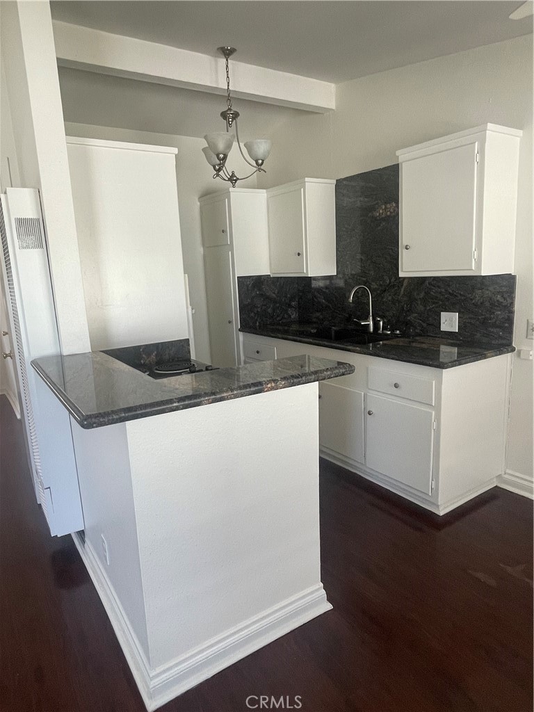 528 Cherry, Unit B Long Beach, CA 90802 - Photo 8 of 16 a kitchen with granite countertop a sink a counter space and cabinets