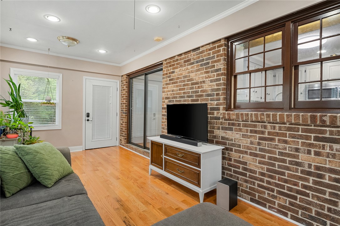 1403 Hanover Road Anderson, SC 29621 - Photo 15 of 40 This inviting living space features warm hardwood floors and a striking brick accent wall.