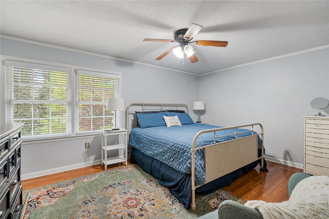 1403 Hanover Road Anderson, SC 29621 - Photo 17 of 40 This inviting bedroom features hardwood flooring, ample natural light, and a ceiling fan for comfort.