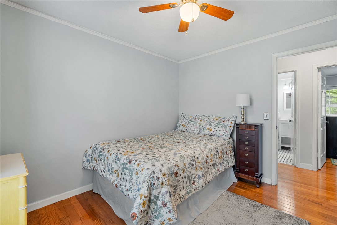 1403 Hanover Road Anderson, SC 29621 - Photo 21 of 40 This cozy bedroom features warm hardwood floors and convenient access to a modern bathroom.