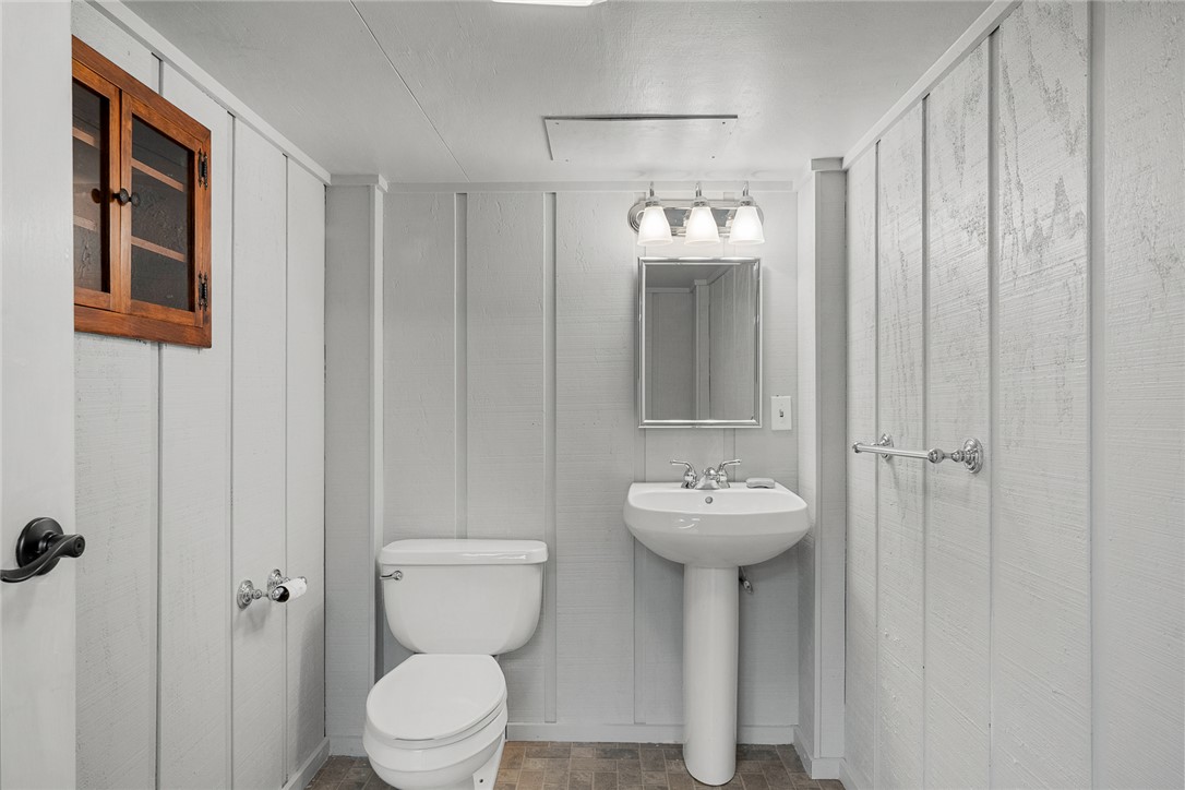 1403 Hanover Road Anderson, SC 29621 - Photo 27 of 40 This bathroom features wainscoting and a pedestal sink, creating a clean and functional space.
