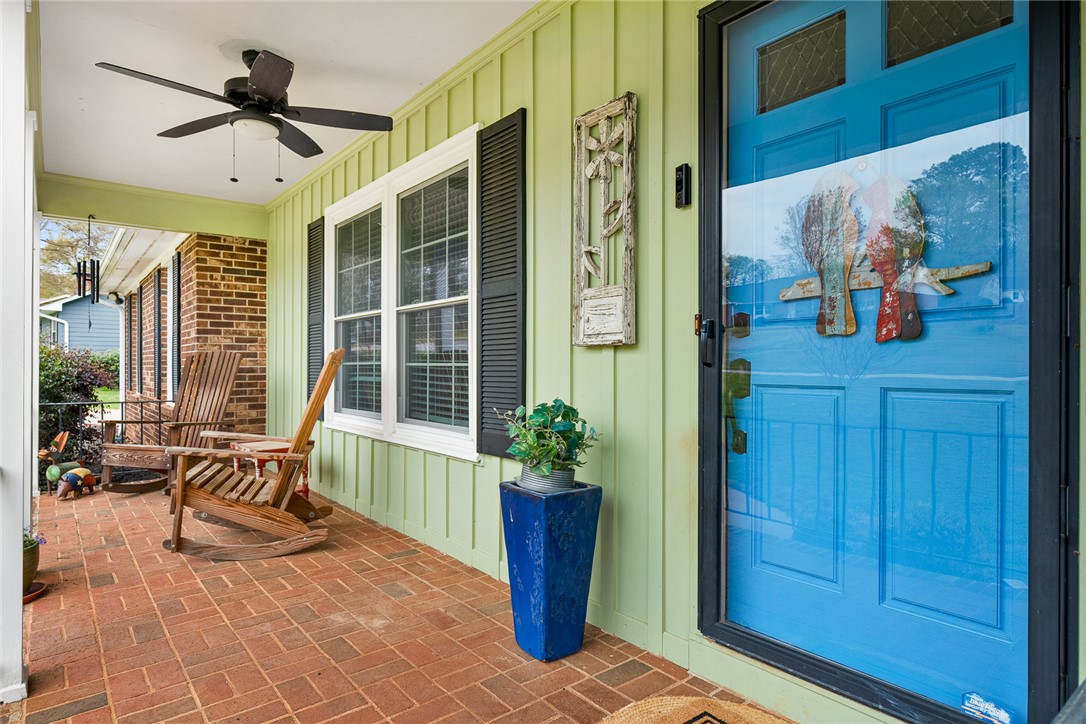 1403 Hanover Road Anderson, SC 29621 - Photo 5 of 40 This inviting porch features a brick floor and a vibrant blue door, offering a warm welcome.