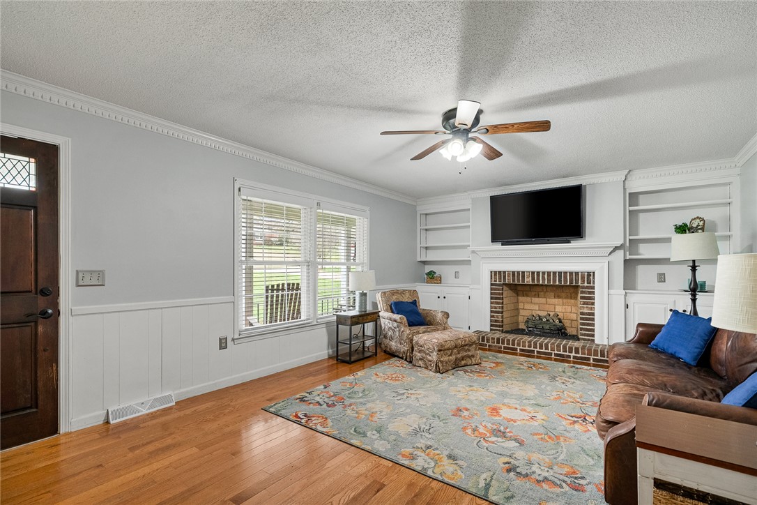1403 Hanover Road Anderson, SC 29621 - Photo 8 of 40 Bright and airy living area with rich wood flooring and a cozy fireplace.