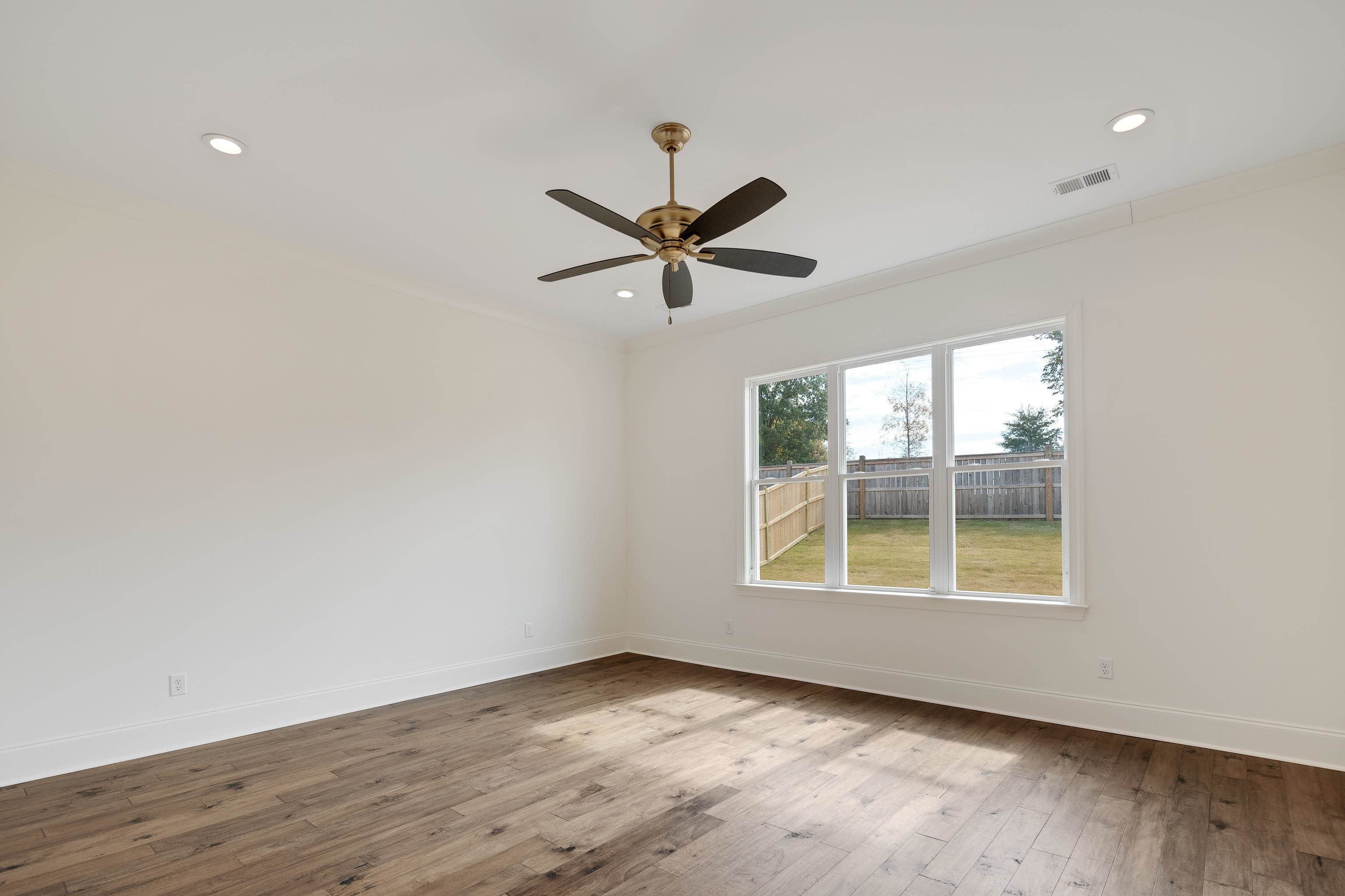 10145 Nighthawk Cove Collierville, TN 38017 - Photo 11 of 25 an empty room with wooden floor and windows