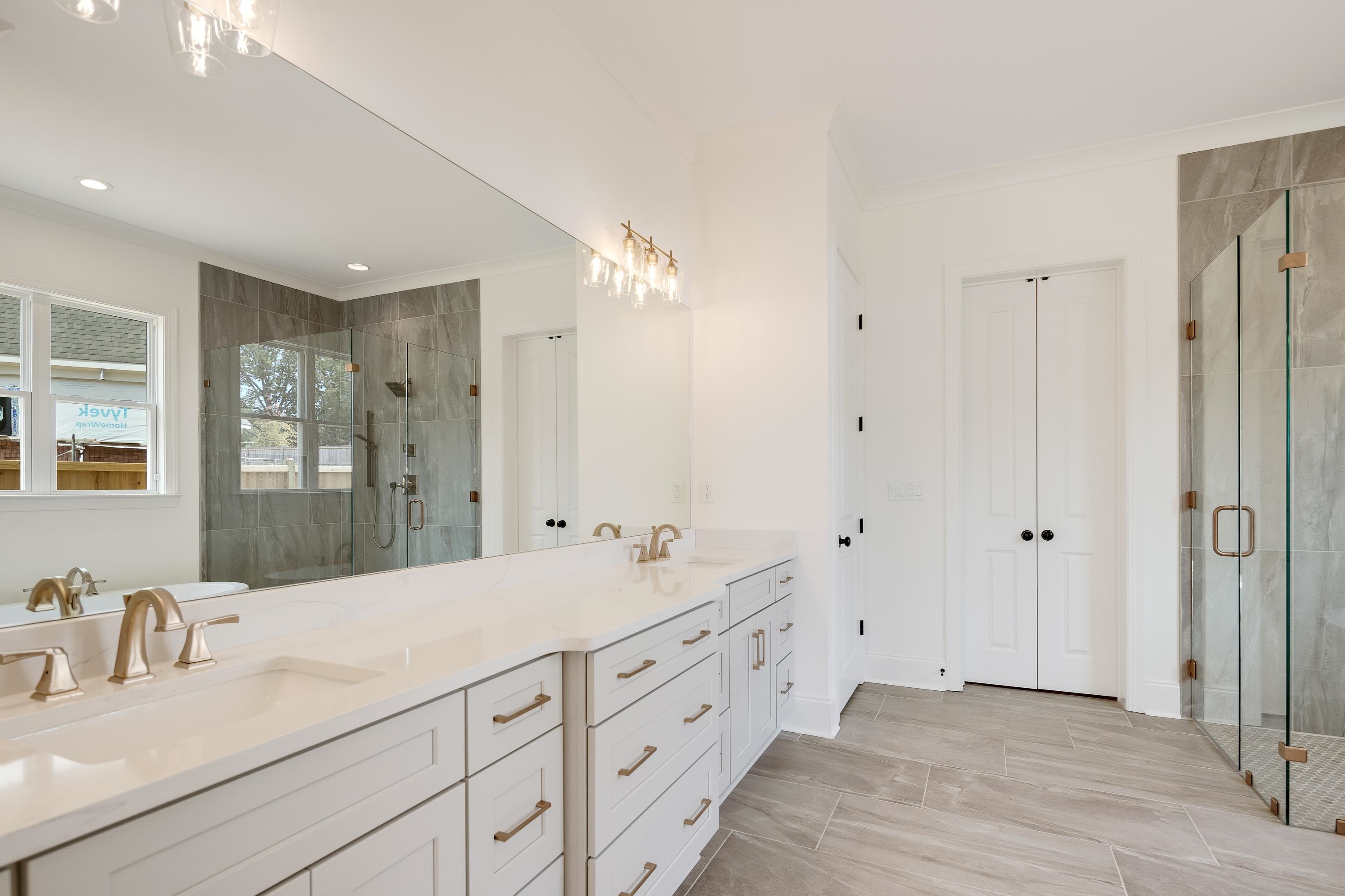 10145 Nighthawk Cove Collierville, TN 38017 - Photo 12 of 25 a bathroom with a double vanity sink mirror and double