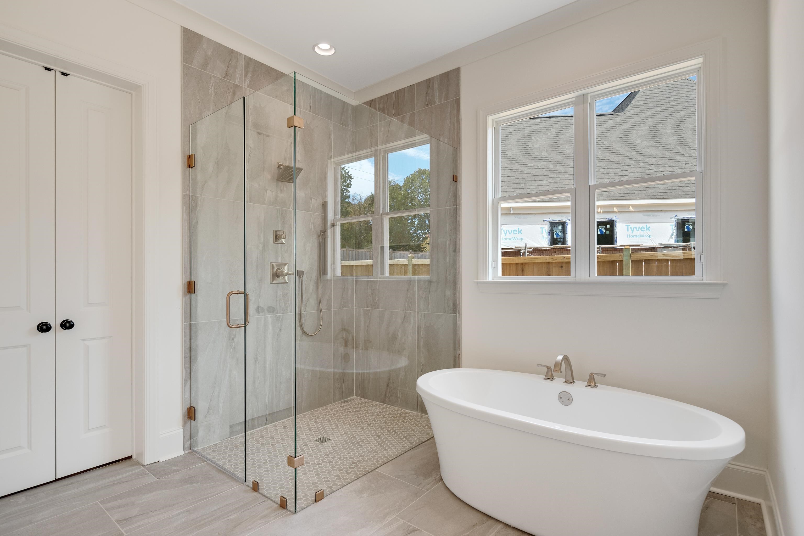 10145 Nighthawk Cove Collierville, TN 38017 - Photo 13 of 25 a bathroom with a bathtub and shower