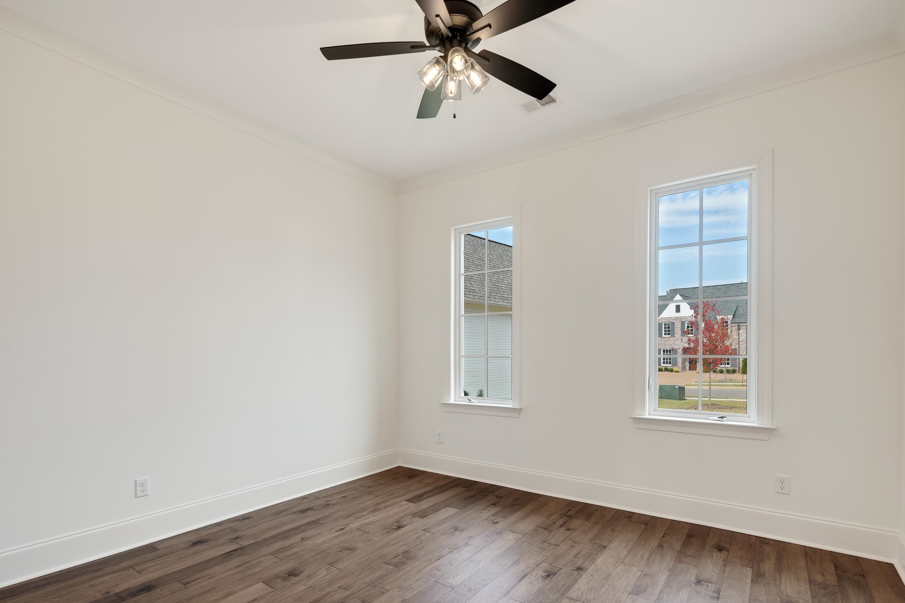 10145 Nighthawk Cove Collierville, TN 38017 - Photo 15 of 25 a view of an empty room with wooden floor and a window