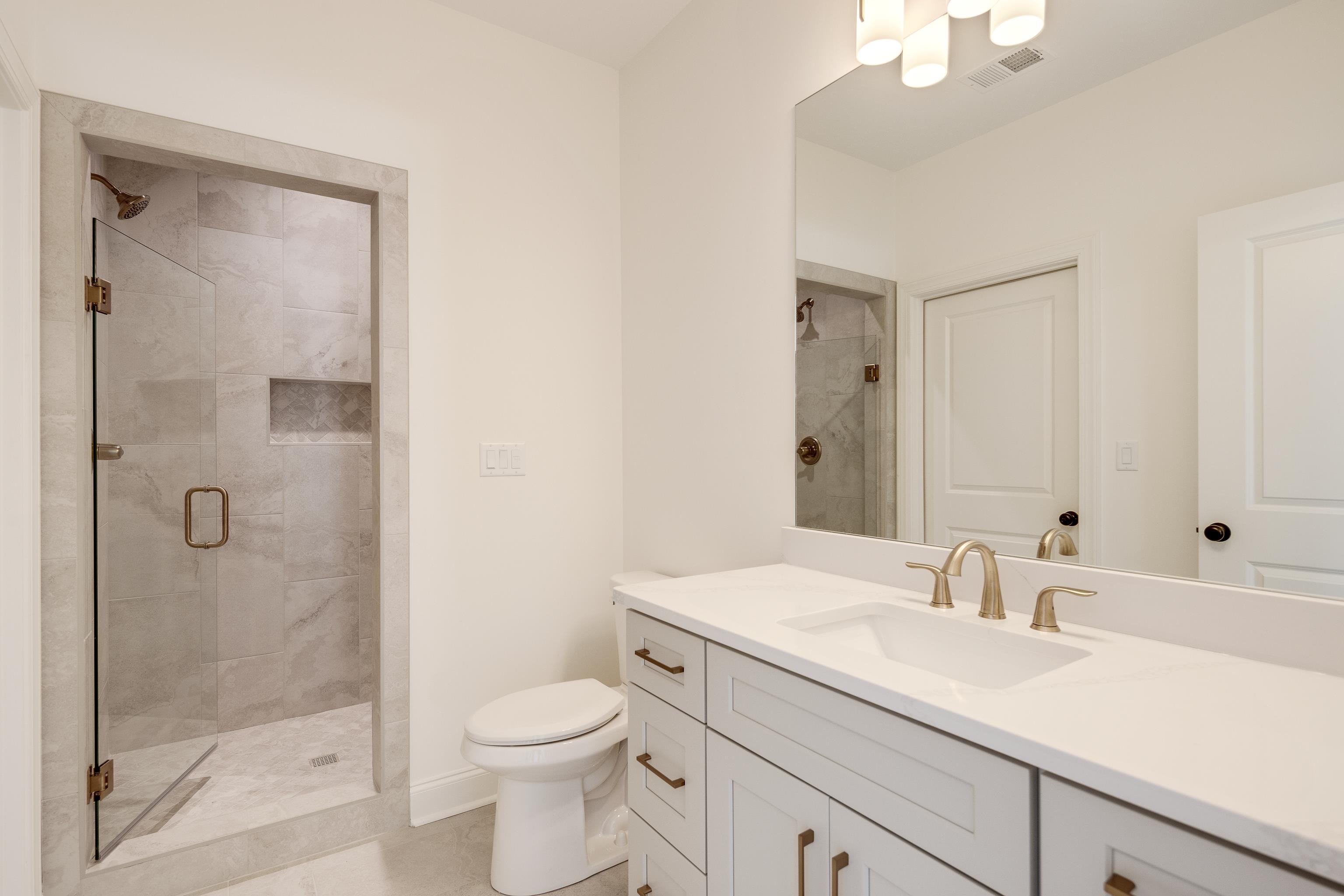 10145 Nighthawk Cove Collierville, TN 38017 - Photo 21 of 25 a bathroom with a sink a toilet and shower