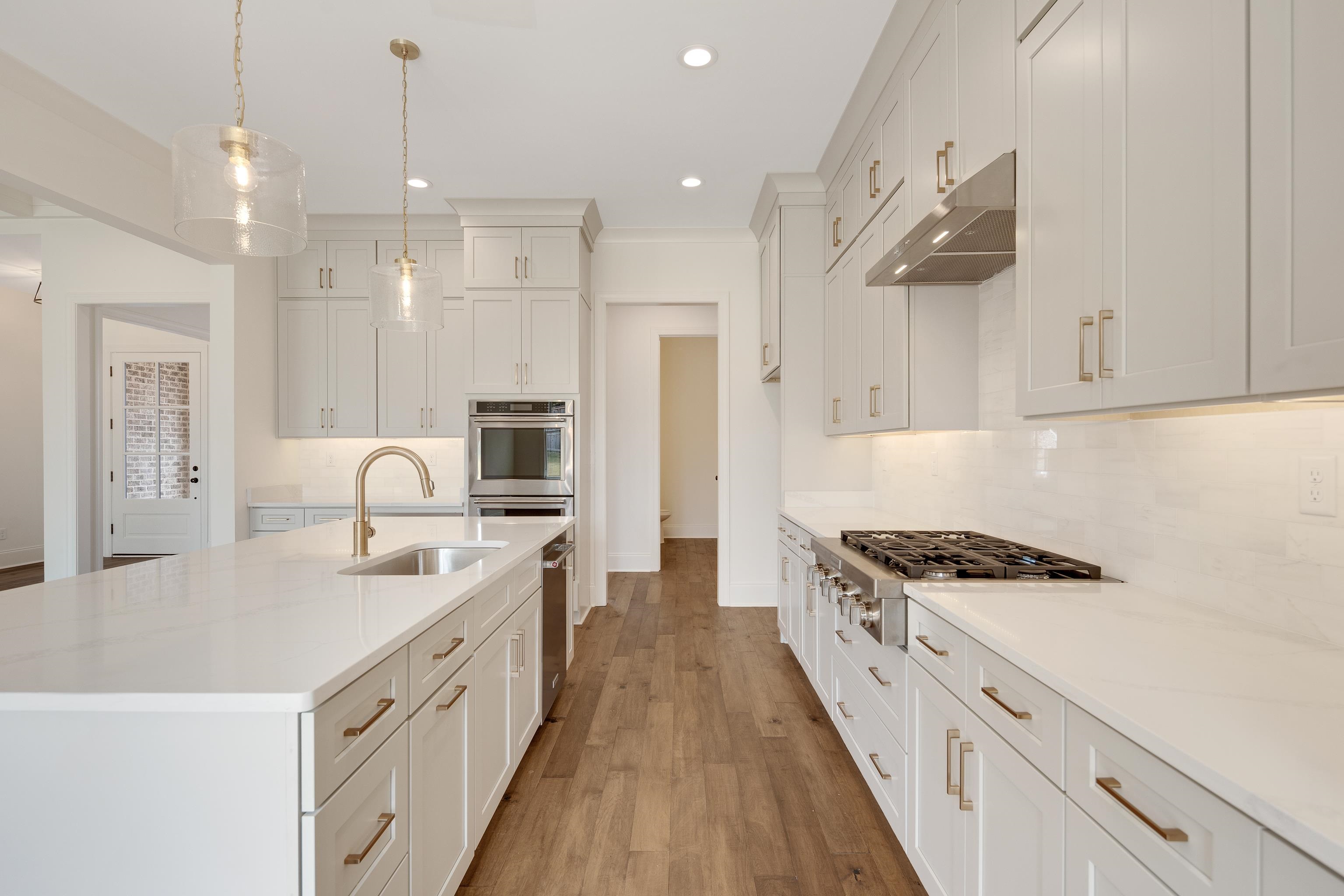 10145 Nighthawk Cove Collierville, TN 38017 - Photo 7 of 25 a kitchen with stainless steel appliances granite countertop a sink stove and refrigerator