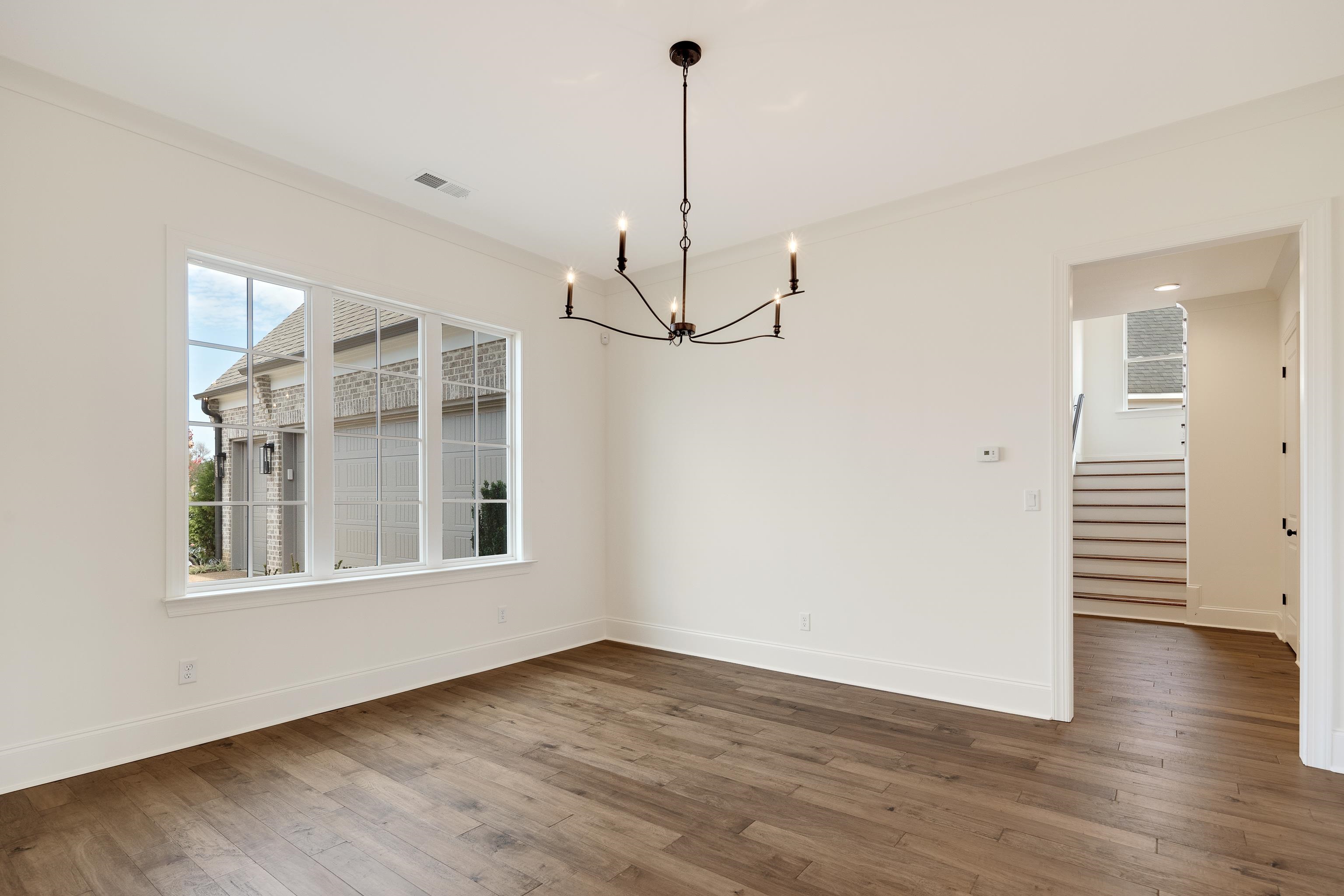 10145 Nighthawk Cove Collierville, TN 38017 - Photo 9 of 25 a view of a room with wooden floor and windows