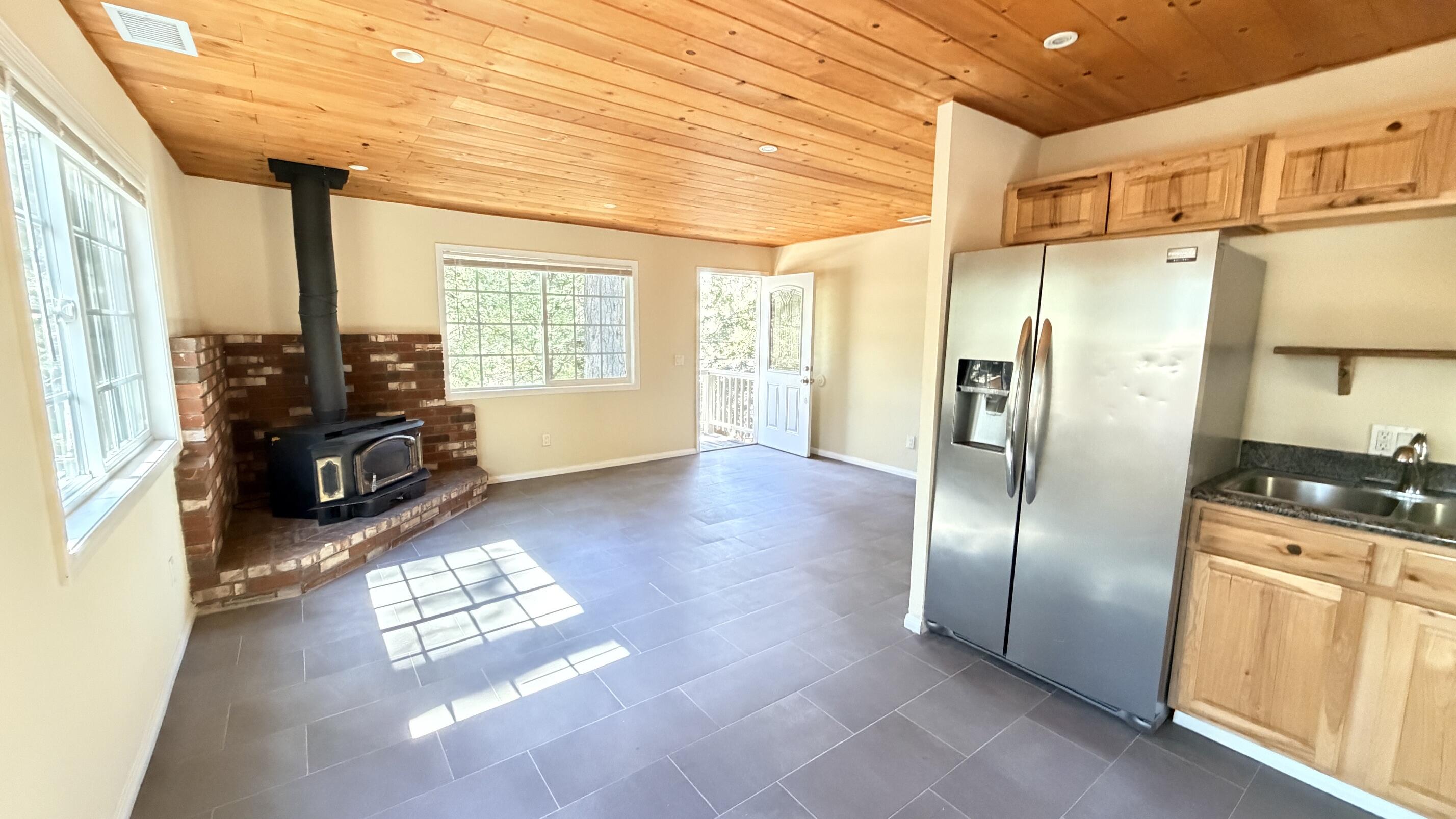 52830 Pine Cove Road Idyllwild, CA 92549 - Photo 5 of 19 a kitchen with granite countertop stainless steel appliances a counter top space and a large window