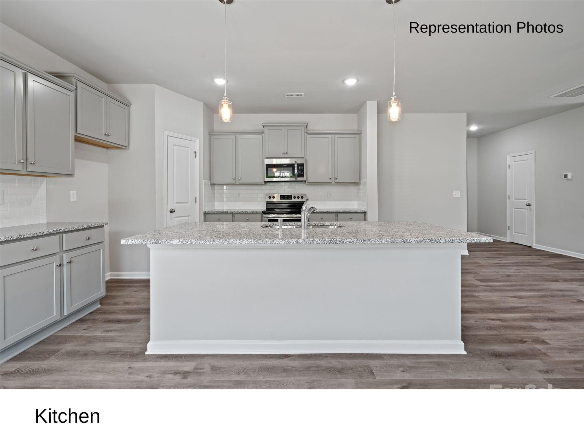 a view of kitchen countertops with cabinets and wooden floor