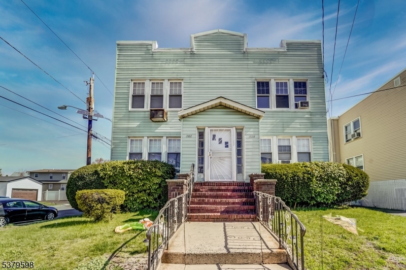 102 Exton Avenue, Unit 1 North Arlington, NJ 07031 - Photo 1 of 18 a front view of a house with garden