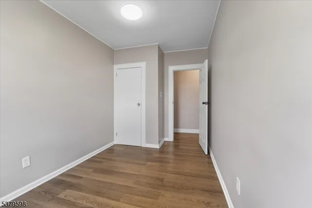 a view of hallway with wooden floor
