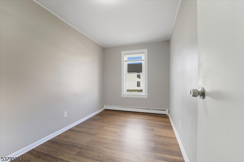 102 Exton Avenue, Unit 1 North Arlington, NJ 07031 - Photo 14 of 18 wooden floor in an empty room with a window