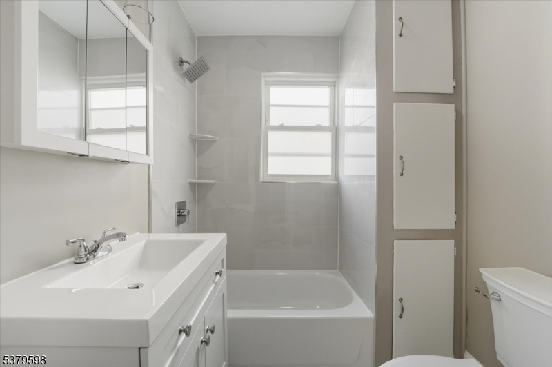 102 Exton Avenue, Unit 1 North Arlington, NJ 07031 - Photo 15 of 18 a bathroom with a sink toilet and shower