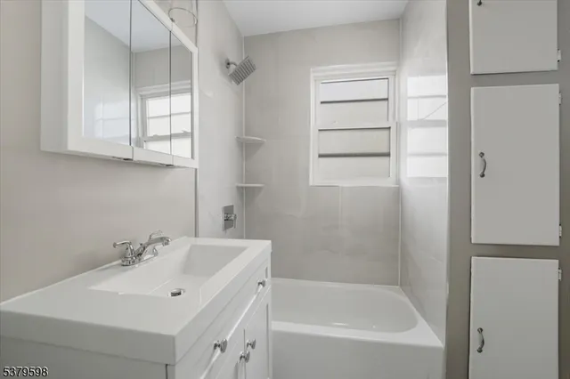 a white bath tub sitting next to a white sink