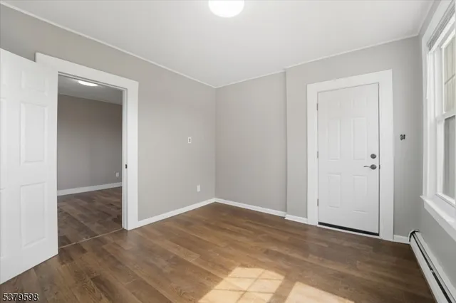 an empty room with wooden floor