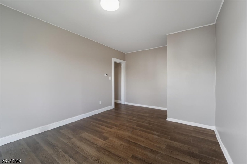 102 Exton Avenue, Unit 1 North Arlington, NJ 07031 - Photo 5 of 18 a view of an empty room with wooden floor