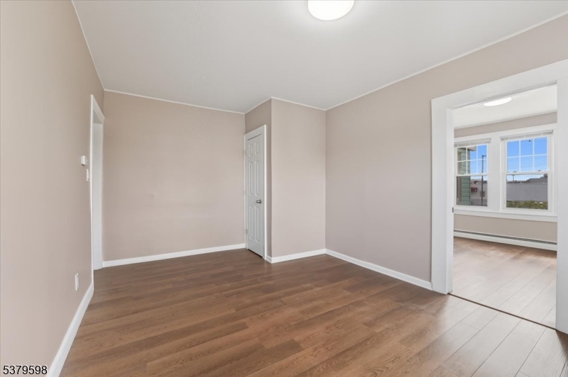 102 Exton Avenue, Unit 1 North Arlington, NJ 07031 - Photo 7 of 18 a view of an empty room with wooden floor