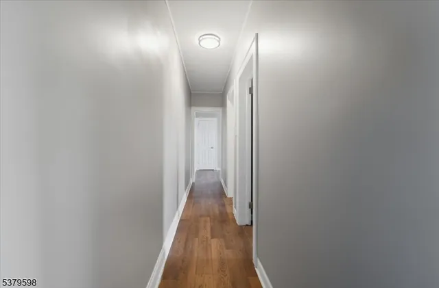 a view of hallway with wooden floor