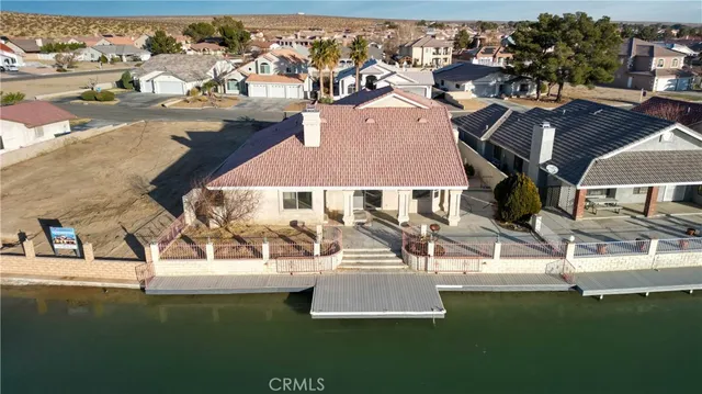 an aerial view of residential houses with outdoor space and swimming pool