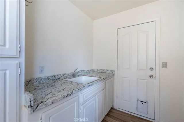 a bathroom with a granite countertop sink and vanity