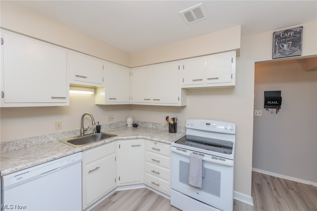 1750 Wagar Road, Unit 206 Rocky River, OH 44116 - Photo 15 of 33 Kitchen with white appliances, light countertops, white cabinetry,