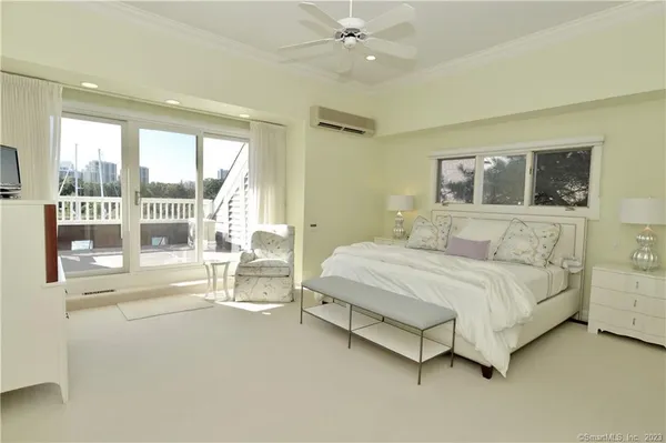 a spacious bedroom with a bed and a large window